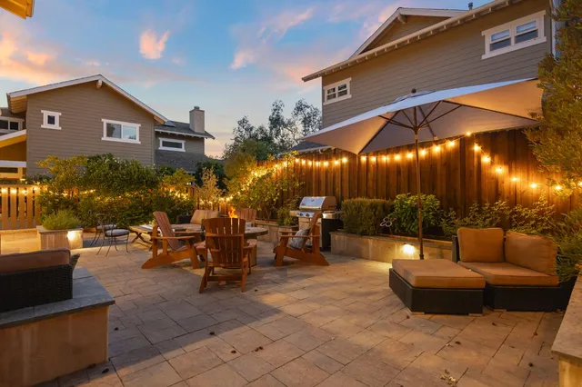 a view of a patio with couches and table and chairs and potted plants