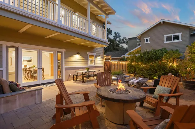 a view of a patio with a table and chairs and potted plants