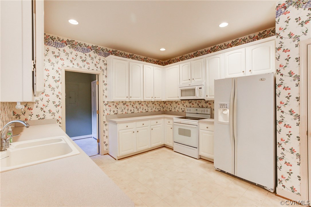13413 Carters Valley Road Chesterfield, VA 23838 - Photo 11 of 25 a kitchen with white cabinets and white appliances