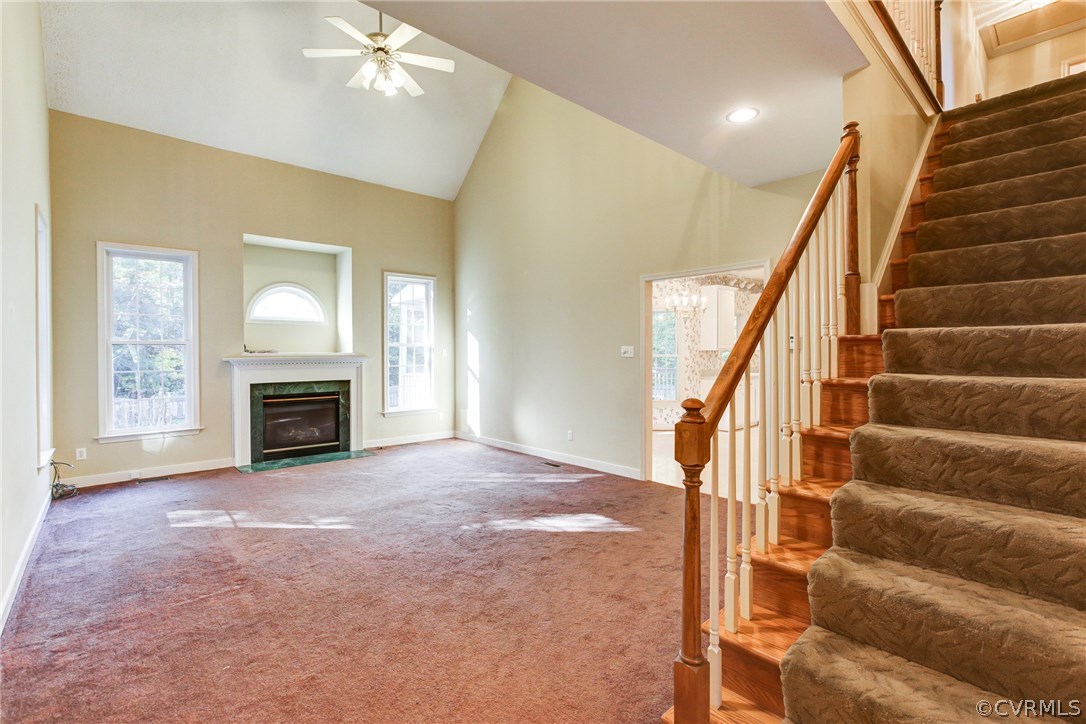 13413 Carters Valley Road Chesterfield, VA 23838 - Photo 8 of 25 a view of an empty room with fireplace stairs and windows