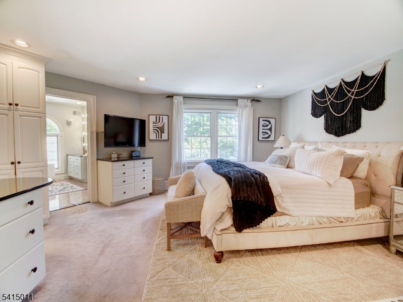 23 Ryerson Road Flemington, NJ 08822 - Photo 19 of 44 a bedroom with a bed and flat tv screen on the dresser
