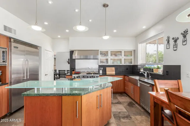 a kitchen with counter top space appliances and windows