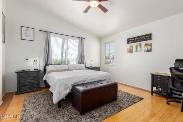 a bed sitting in a bedroom next to a window