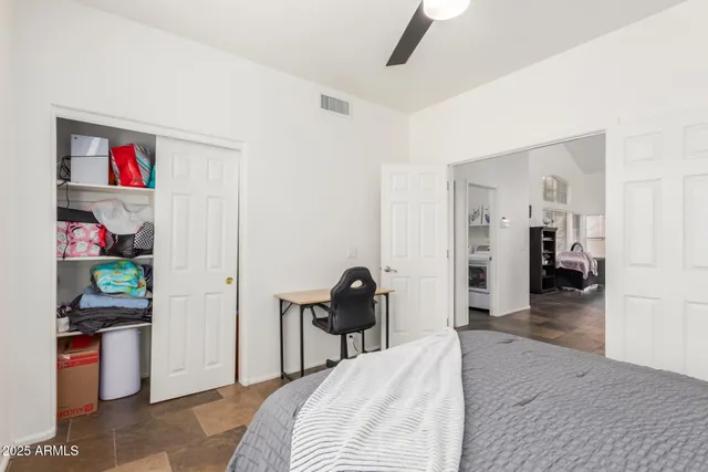 a bedroom with a bed and a view of en suite bathroom