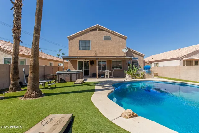 a view of a patio with swimming pool table and chairs