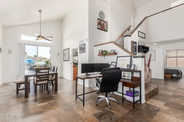 a workspace with lots of furniture and white walls