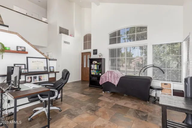 a view of a workspace with furniture and a window