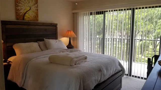 a bedroom with a bed and a lamp