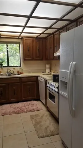 a kitchen with a stove sink and cabinets