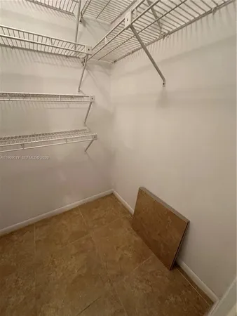 a kitchen with granite countertop a stove cabinets and white appliances