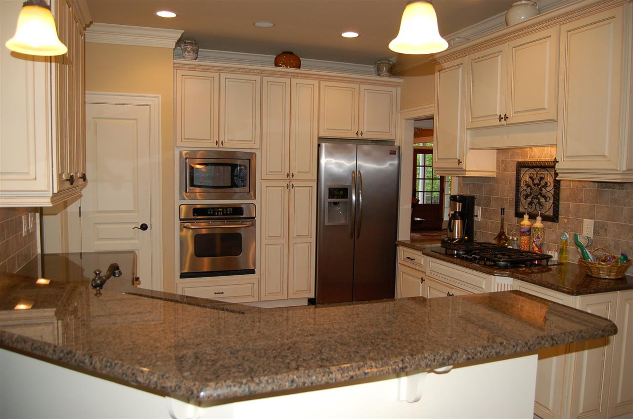 8111 Henderson Road Apex, NC 27539 - Photo 10 of 25 Beautiful cabinetry with granite countertops stainless steel appliances and a gas range Kitchen