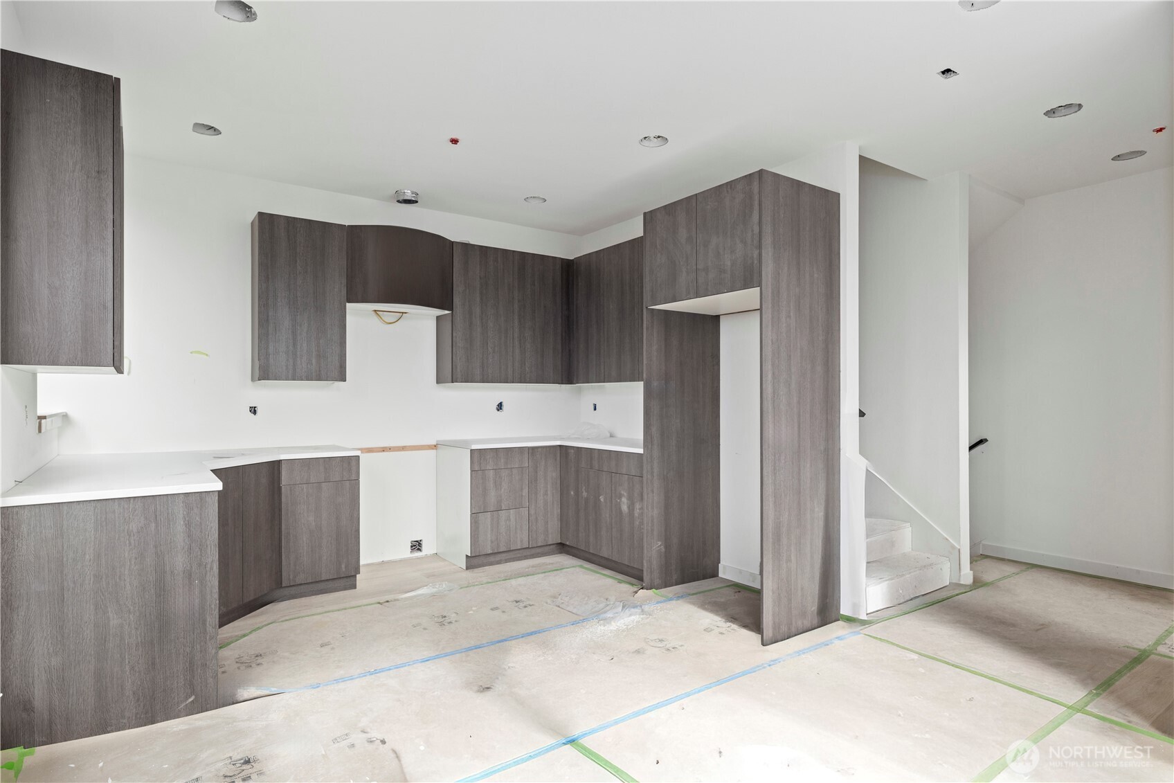2230 Northwest 60th Street Seattle, WA 98107 - Photo 5 of 14 a large white kitchen with a sink and cabinets