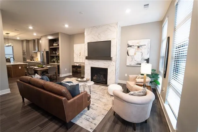 a living room with furniture a flat screen tv and a fireplace