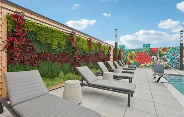 a balcony with furniture and a potted plant