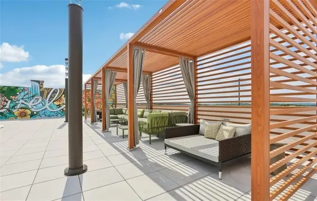 a view of a patio with table and chairs and potted plants