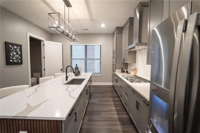 a large white kitchen with stainless steel appliances