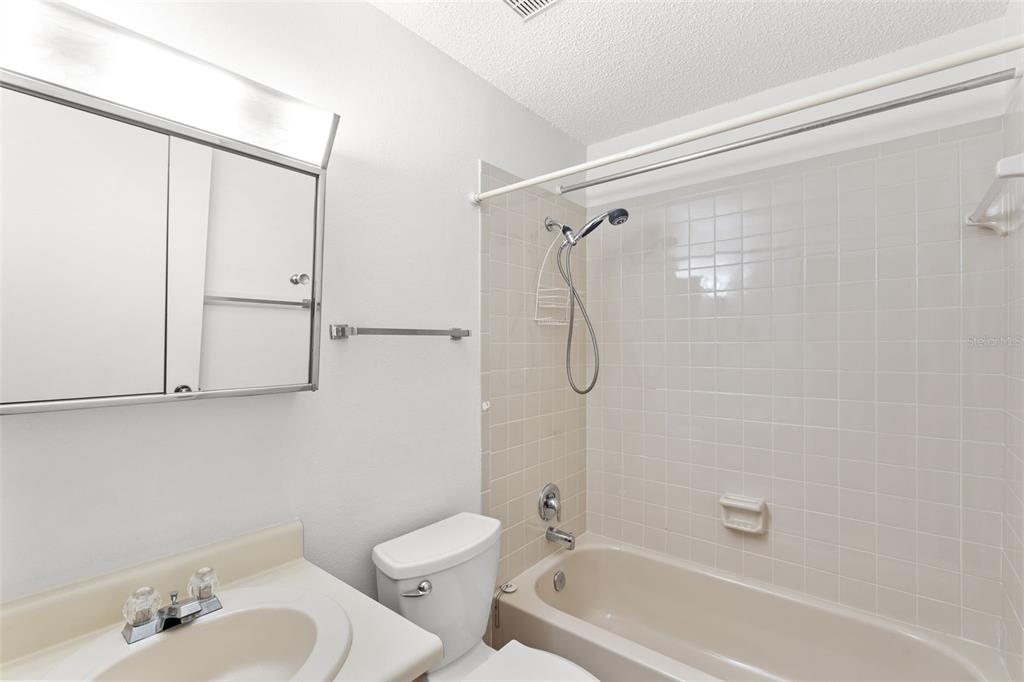 1114 Castlemay Circle Dunedin, FL 34698 - Photo 12 of 21 a bathroom with a bathtub shower sink vanity and toilet