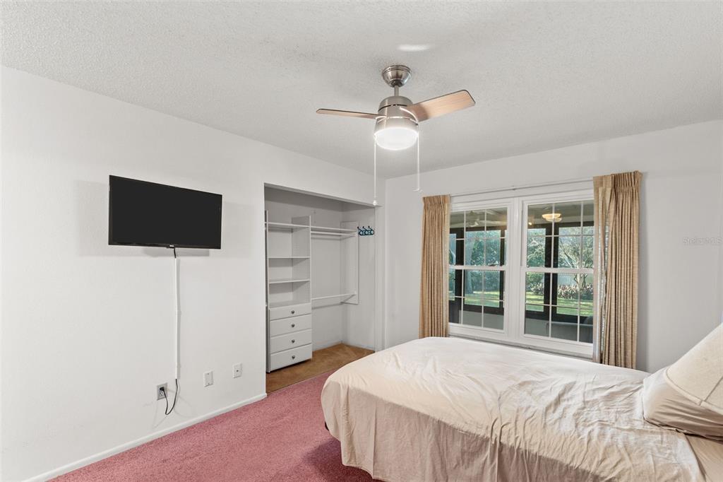 1114 Castlemay Circle Dunedin, FL 34698 - Photo 14 of 21 a bedroom with a bed and a flat screen tv