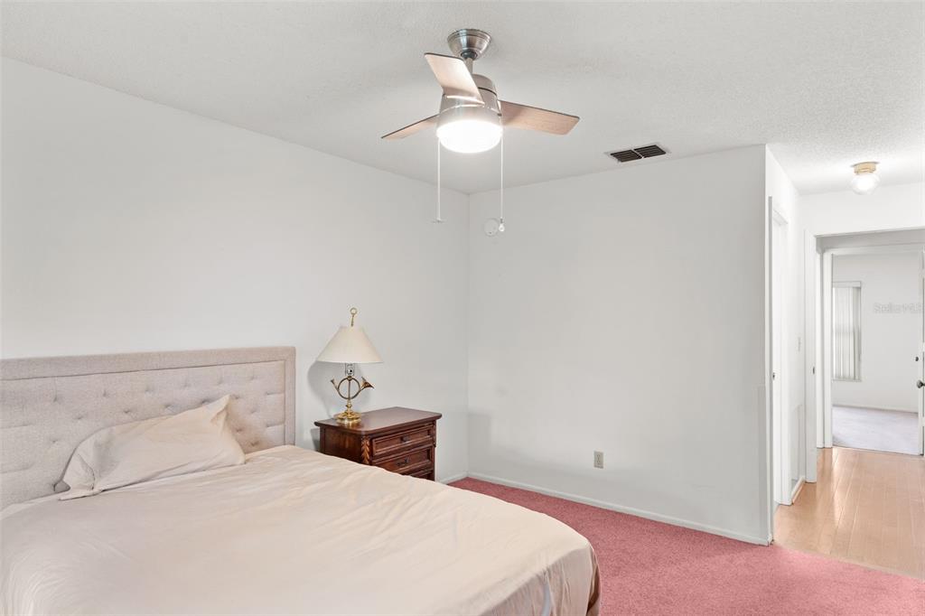 1114 Castlemay Circle Dunedin, FL 34698 - Photo 16 of 21 a bedroom with a bed and a lamp