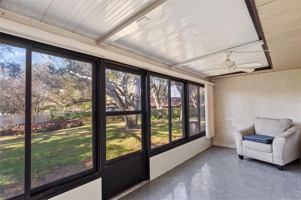1114 Castlemay Circle Dunedin, FL 34698 - Photo 18 of 21 a living room with furniture and a floor to ceiling window