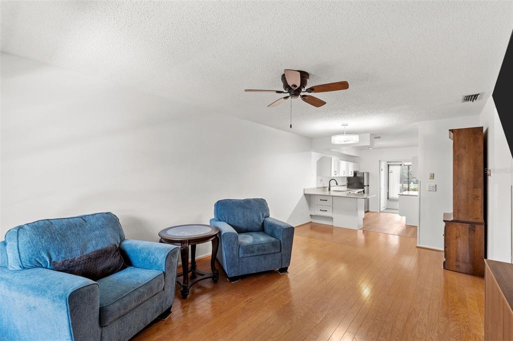 1114 Castlemay Circle Dunedin, FL 34698 - Photo 2 of 21 a living room with furniture and a ceiling fan