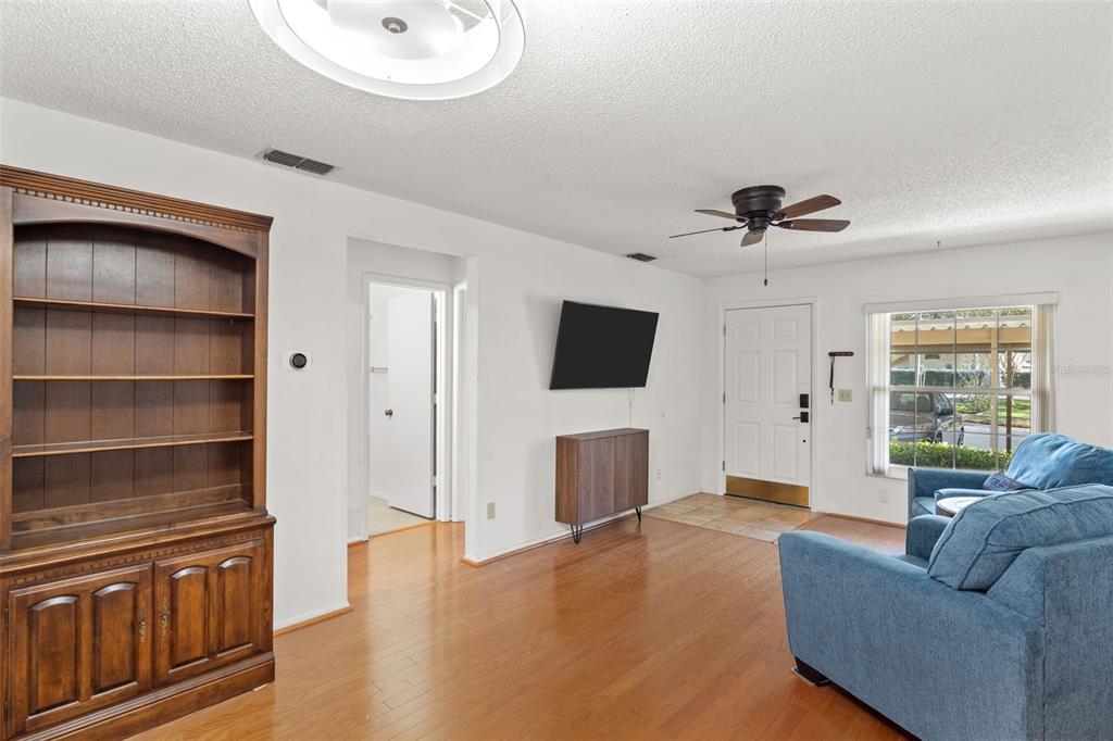 1114 Castlemay Circle Dunedin, FL 34698 - Photo 4 of 21 a living room with furniture and a flat screen tv