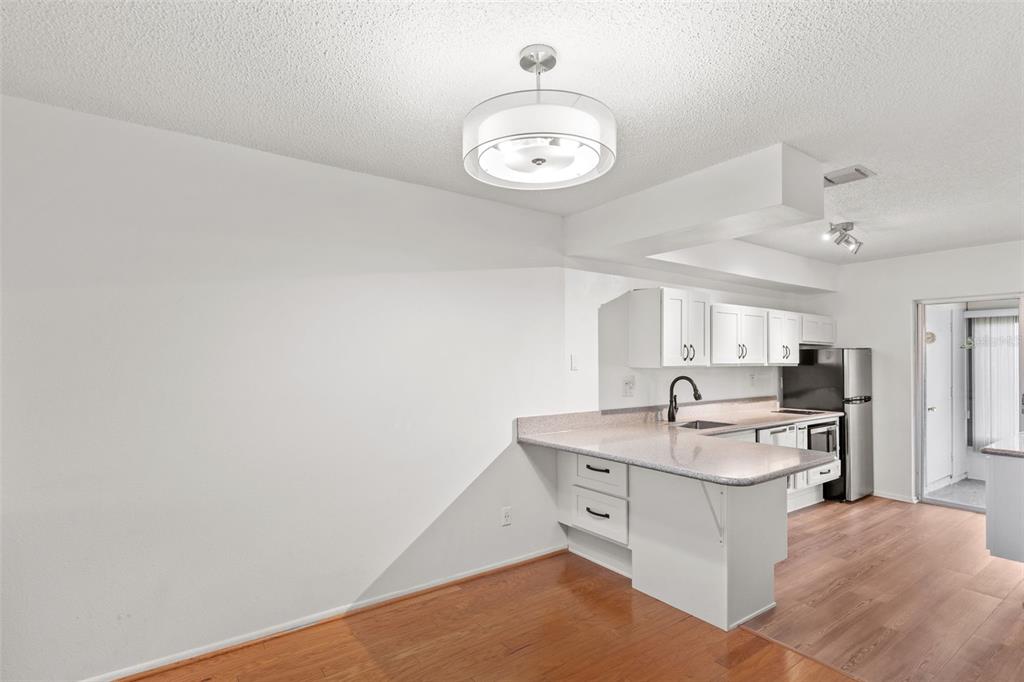 1114 Castlemay Circle Dunedin, FL 34698 - Photo 5 of 21 a open kitchen with cabinets stove and a sink