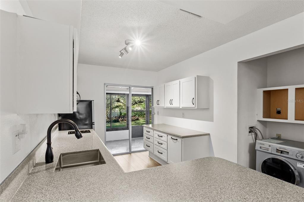 1114 Castlemay Circle Dunedin, FL 34698 - Photo 6 of 21 a living room with furniture a window and a fireplace