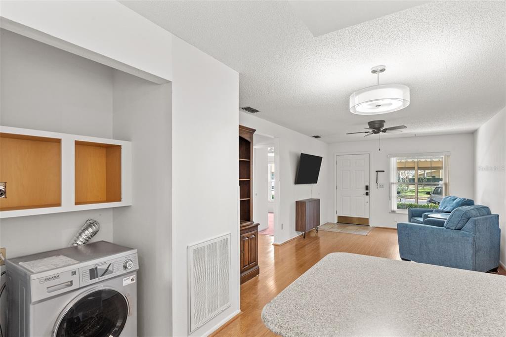 1114 Castlemay Circle Dunedin, FL 34698 - Photo 9 of 21 a living room with furniture and a chandelier