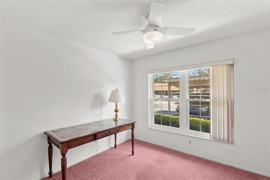 1114 Castlemay Circle Dunedin, FL 34698 - Photo 10 of 21 a room with furniture and a window