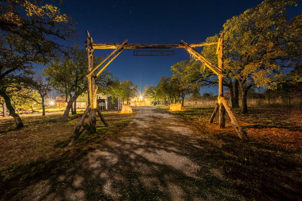 770 Sand Lane Santo, TX 76472 - Photo 14 of 40 a backyard of a house with lots of green space