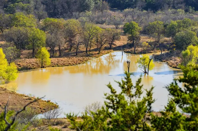 a dining room with lots of furniture and a chandelier