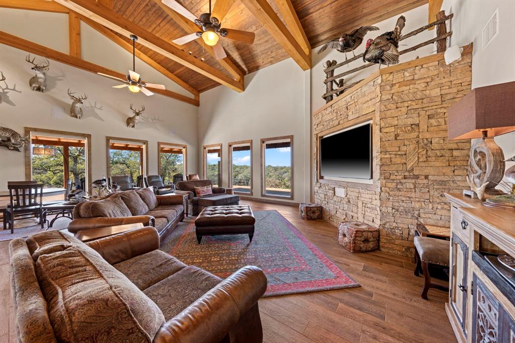 770 Sand Lane Santo, TX 76472 - Photo 28 of 40 a living room with furniture a flat screen tv and a fireplace