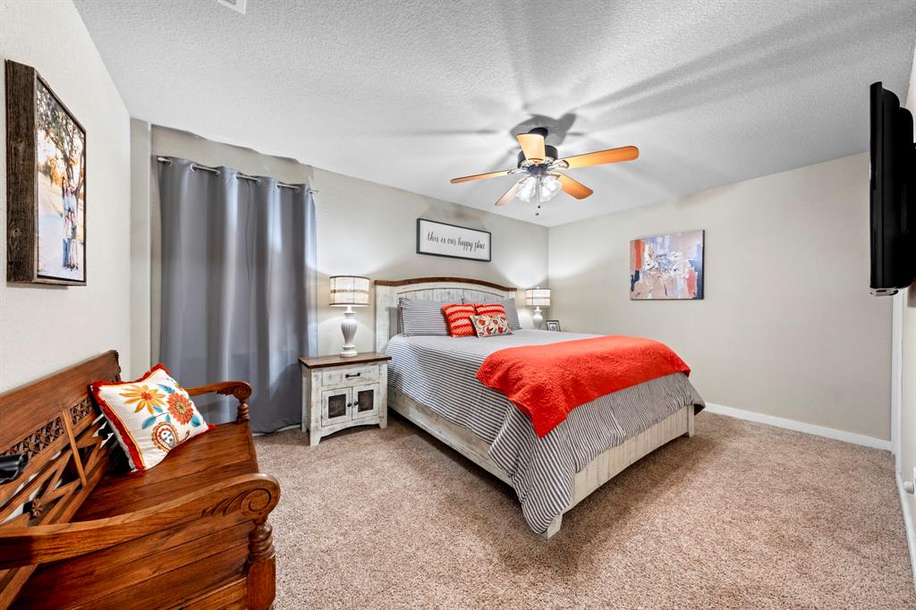 770 Sand Lane Santo, TX 76472 - Photo 29 of 40 a bedroom with a bed and a chandelier