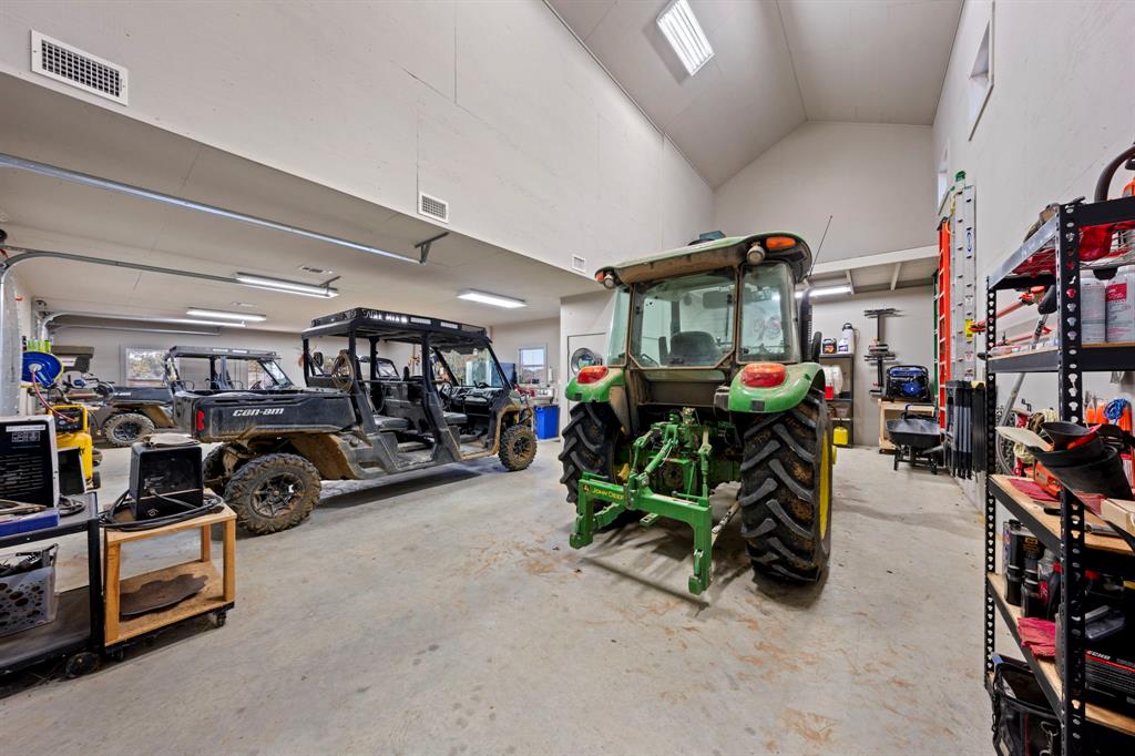 770 Sand Lane Santo, TX 76472 - Photo 37 of 40 a view of parking garage with cars and other equipment