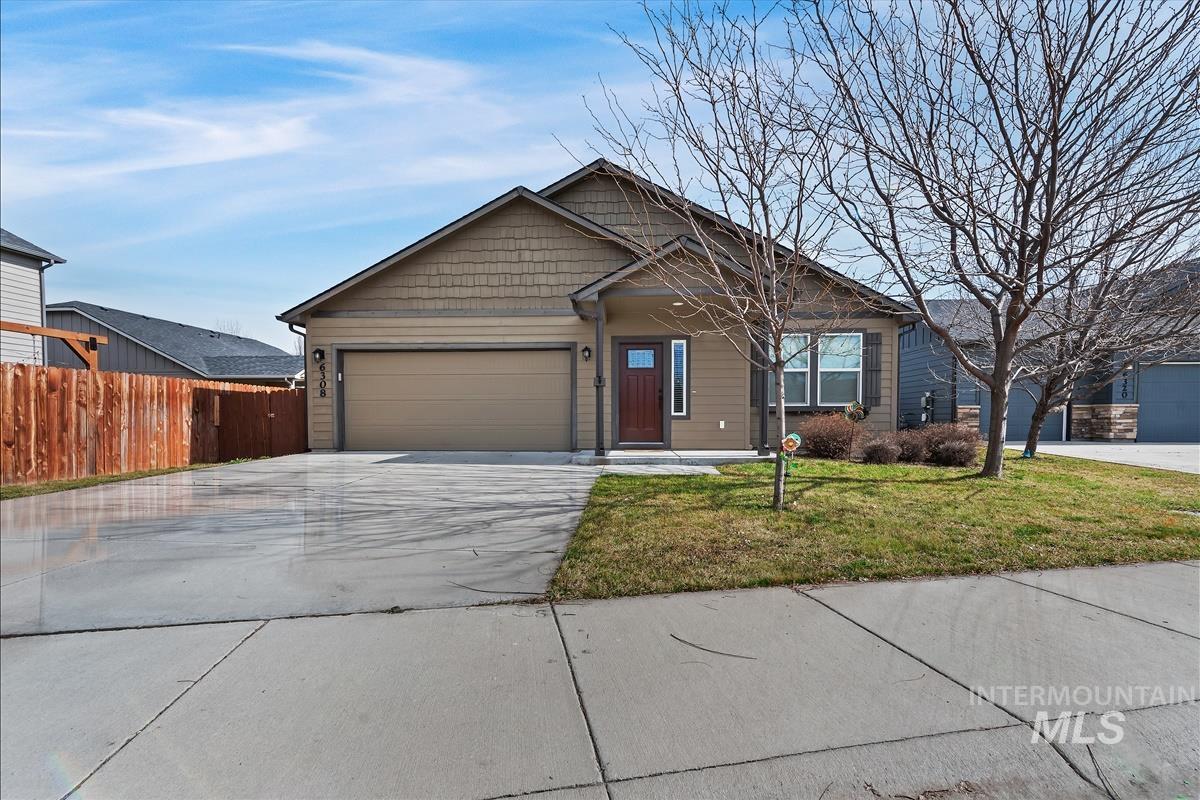 View of front facade featuring concrete driveway and an attached garage