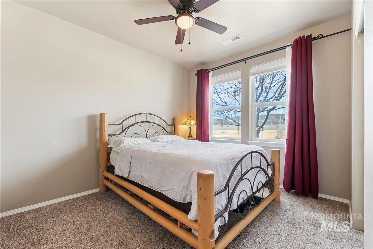 6308 South Kelso Way Boise, ID 83709 - Photo 13 of 35 Bedroom with ceiling fan and carpet floors