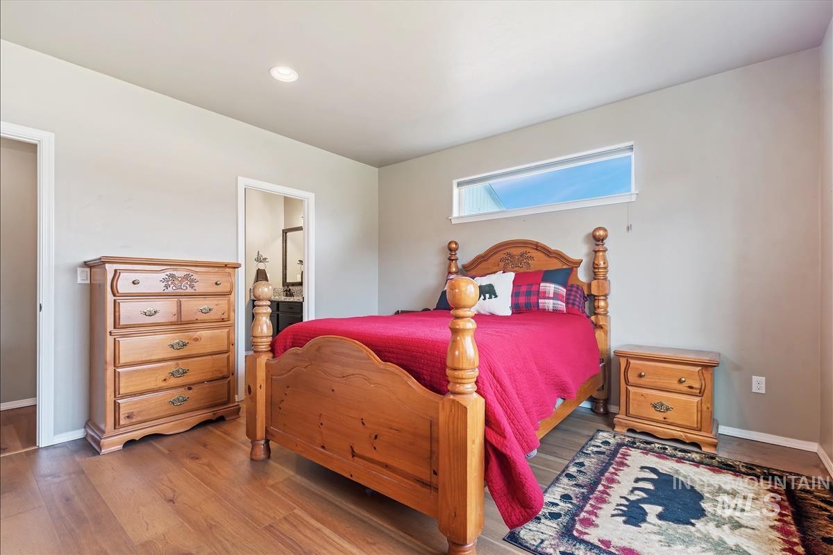 6308 South Kelso Way Boise, ID 83709 - Photo 18 of 35 Bedroom featuring wood finished floors and ensuite bath