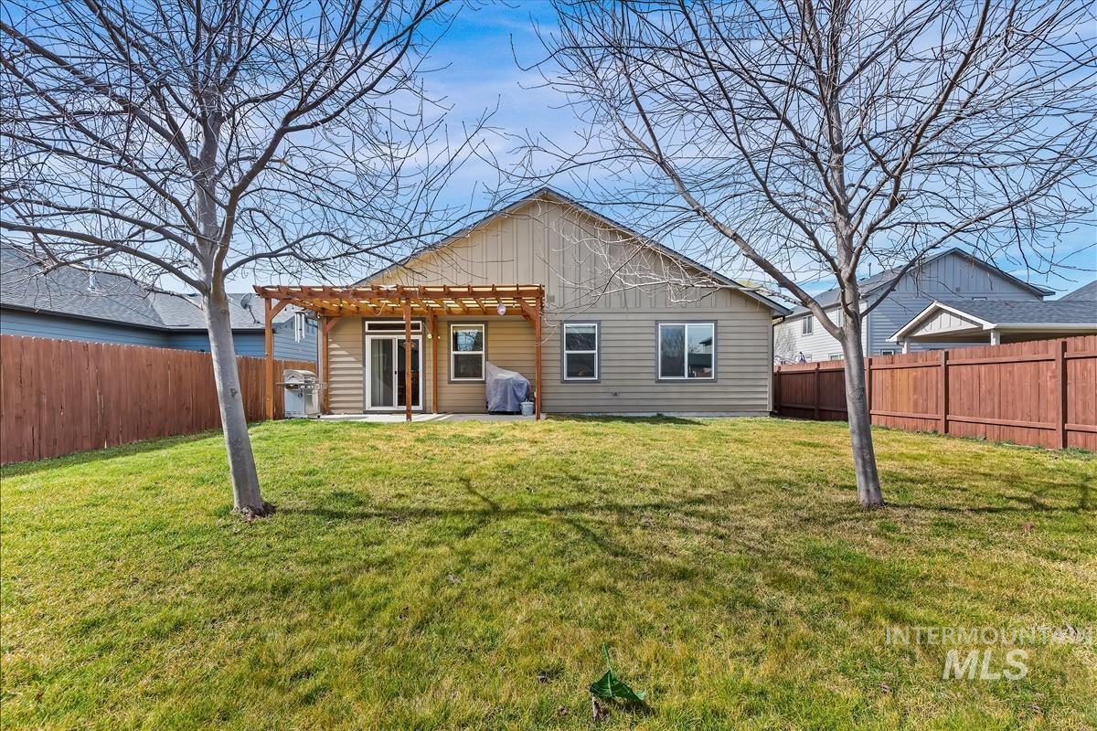 6308 South Kelso Way Boise, ID 83709 - Photo 27 of 35 Back of property featuring a patio area and a fenced backyard
