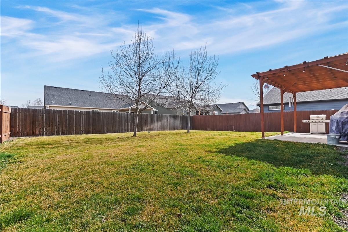 6308 South Kelso Way Boise, ID 83709 - Photo 30 of 35 Fenced backyard with a patio and a pergola