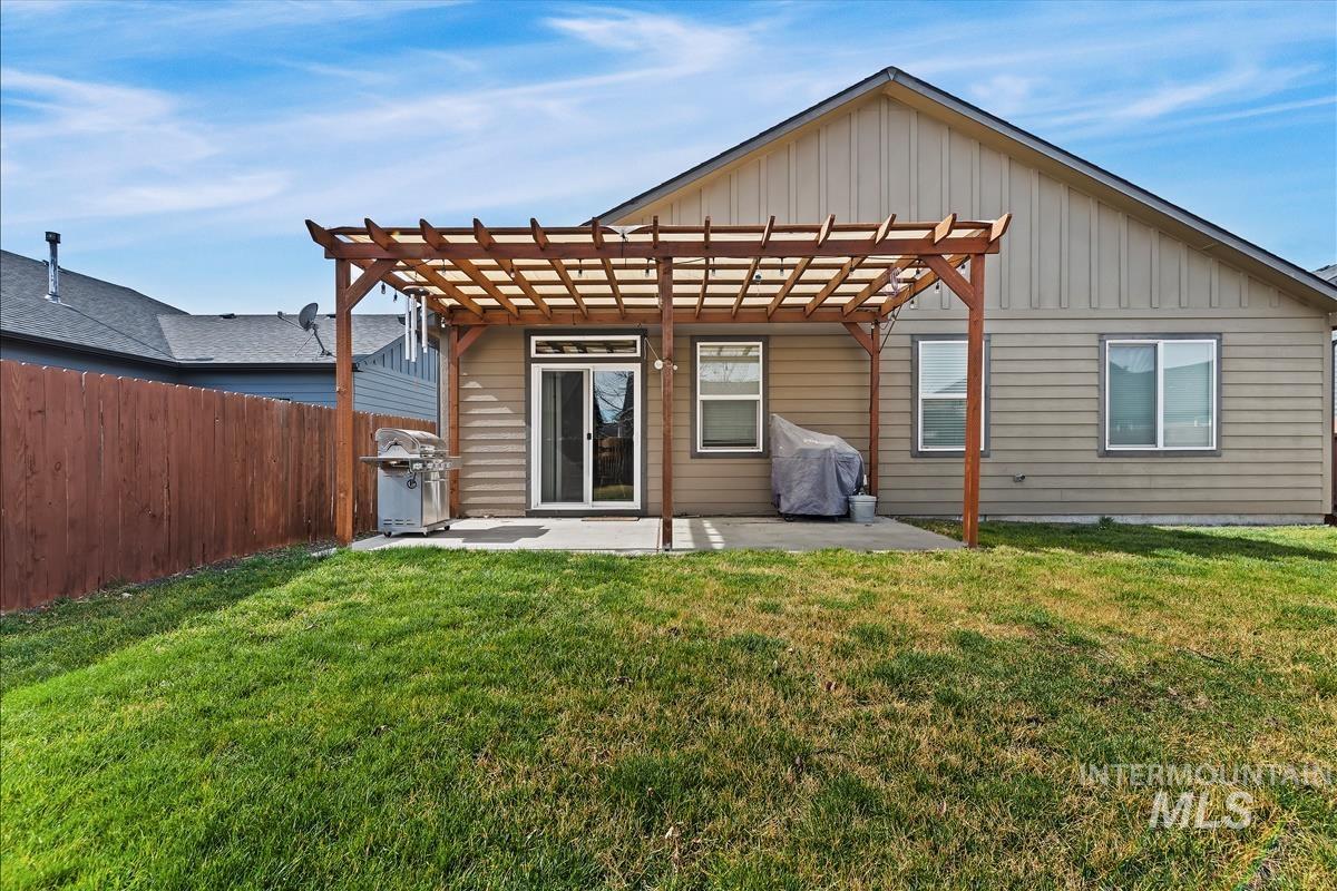 6308 South Kelso Way Boise, ID 83709 - Photo 31 of 35 Back of house featuring board and batten siding, a pergola, and a patio area
