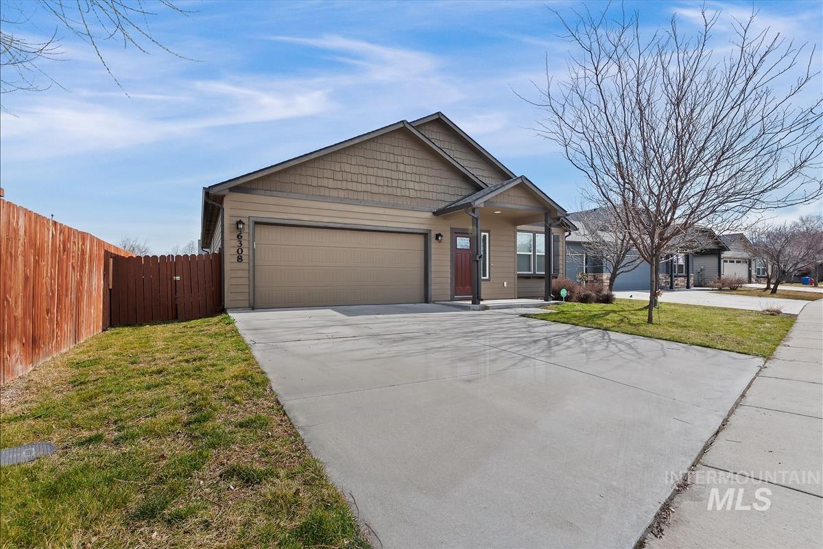 6308 South Kelso Way Boise, ID 83709 - Photo 32 of 35 View of front of property with concrete driveway, an attached garage, and a gate