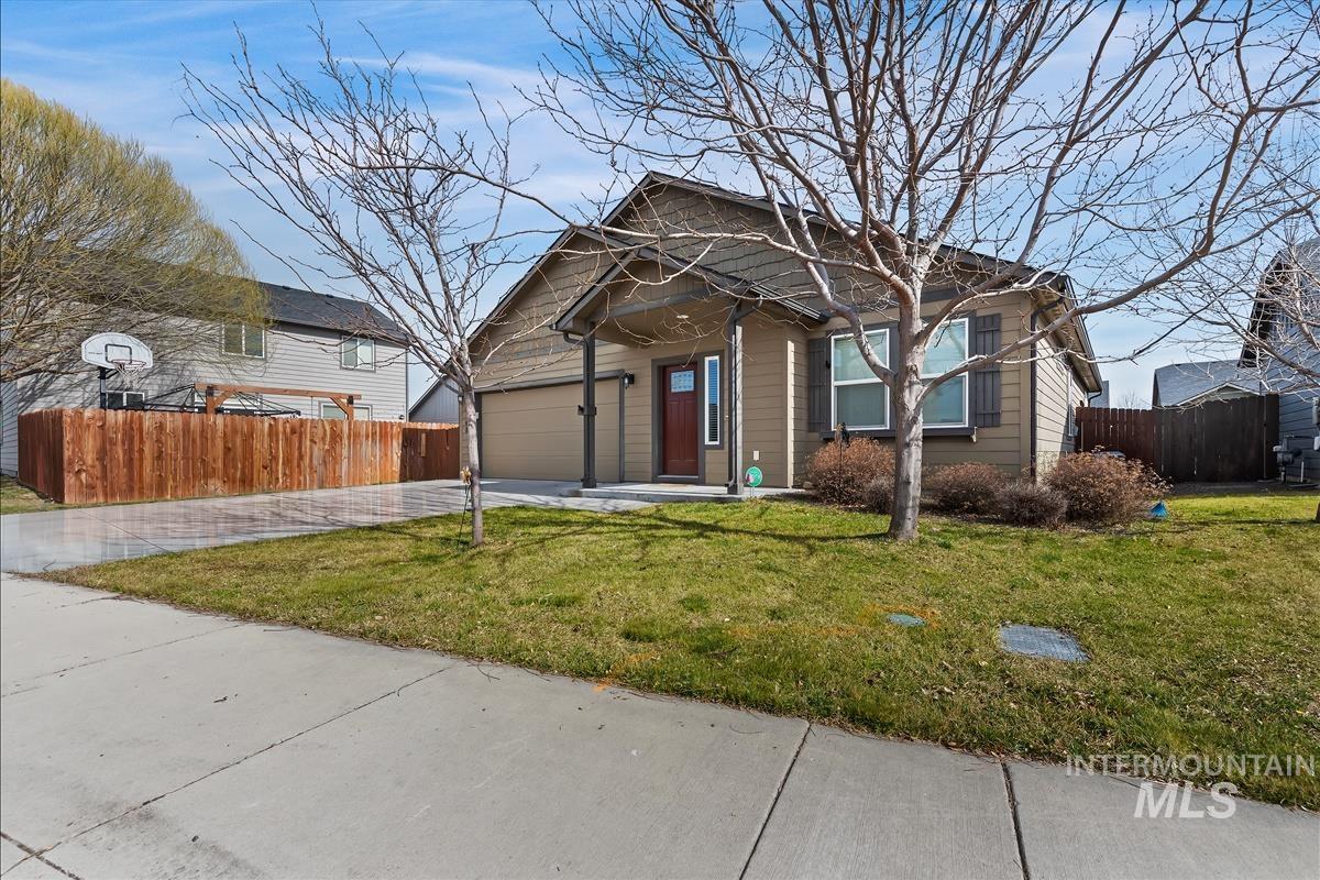 6308 South Kelso Way Boise, ID 83709 - Photo 33 of 35 View of front of home with driveway, a porch, and a garage