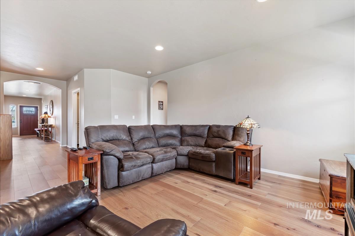 6308 South Kelso Way Boise, ID 83709 - Photo 5 of 35 Living area with arched walkways, light wood-type flooring, and recessed lighting