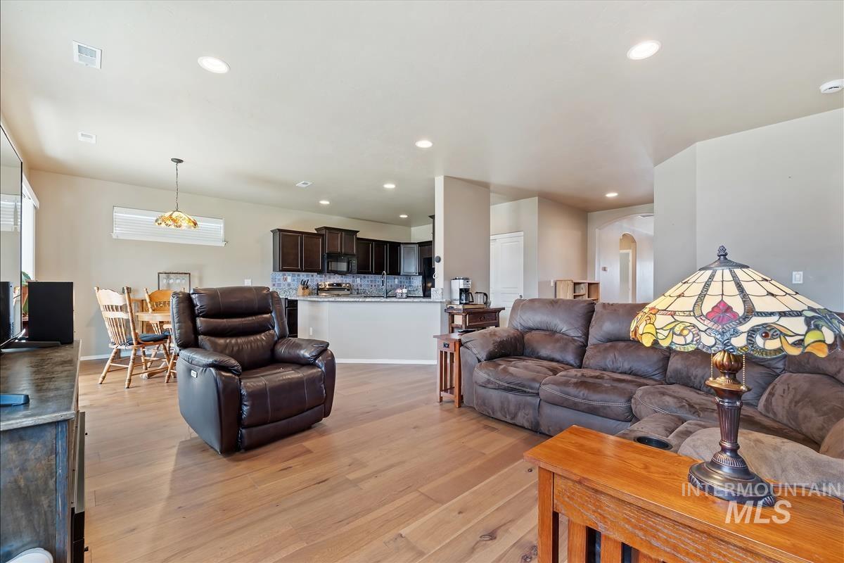 6308 South Kelso Way Boise, ID 83709 - Photo 6 of 35 Living area featuring arched walkways, light wood-type flooring, and recessed lighting