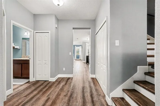a view of a room with wooden floor and bathroom