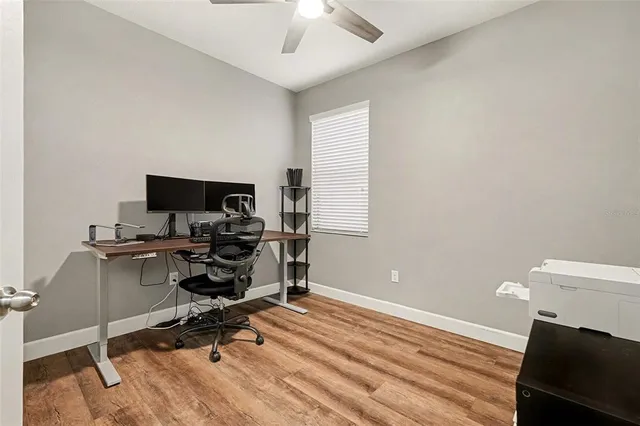 a view of a workspace with furniture and a window