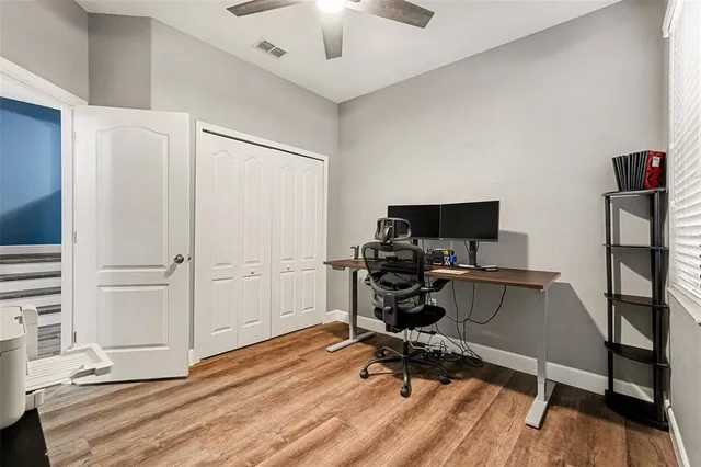 a view of a workspace with furniture and wooden floor