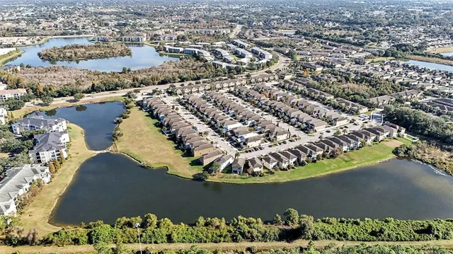 an aerial view of a residential houses with outdoor space