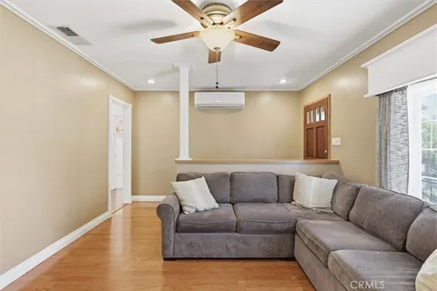 a living room with furniture and a ceiling fan